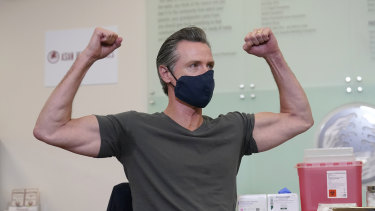 California Governor Gavin Newsom gestures after receiving a Moderna COVID-19 vaccine booster shot in Oakland, California. 