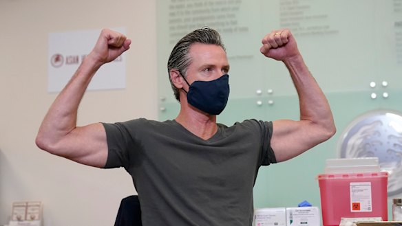 California Governor Gavin Newsom gestures after receiving a Moderna COVID-19 vaccine booster shot in Oakland, California. 