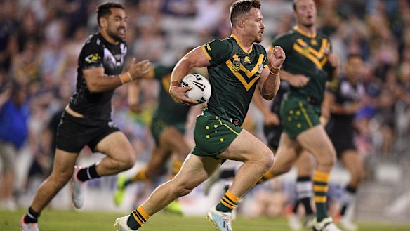 Kangaroos hooker Damien Cook bursts clear to score against New Zealand in Wollongong on Friday night.