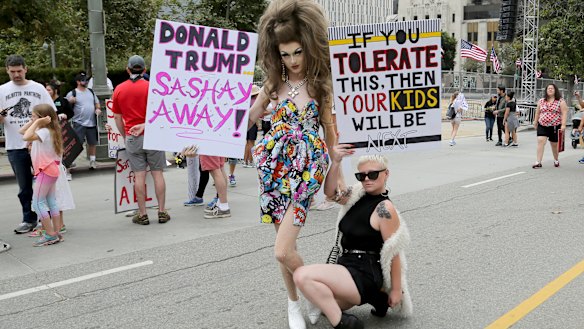 Demonstrators hold signs as they participate in the 'Families Belong Together: Freedom for Immigrants' march on Saturday in Los Angeles.