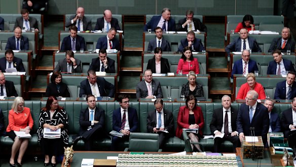 Female Liberal MPs wear red in a show of solidarity in the House of Representatives on Monday. 