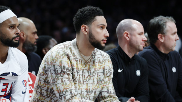 Ben Simmons sits alongside fellow Australian Patty Mills on the Brooklyn Nets bench last season.