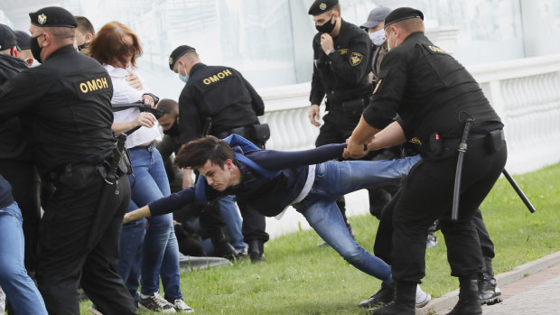 Police officers detain protesters during a protest rally against the removal of opposition candidates from the presidential elections in Minsk on July 14.