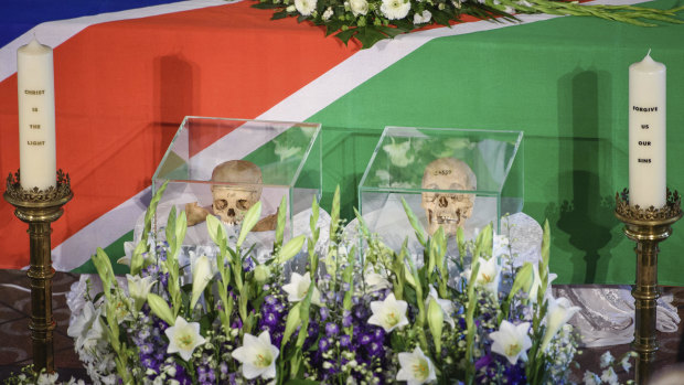 The skulls of two people killed in the  the Herero and Nama uprising between 1904 and 1908 are flanked by candles during a ceremony in Berlin in August.