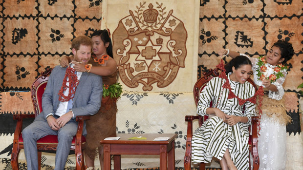 Britain's Prince Harry and Meghan, Duchess of Sussex, are given flower garlands at the Fa'onelua Convention Centre in Nuku'alofa, Tonga.