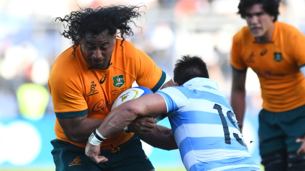 Pone Fa’amausili of Australia attempts to avoid a tackle from Facundo Isa of Argentina.