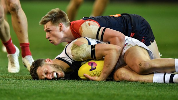 Sam Menegola is tackled by Charlie Spargo.