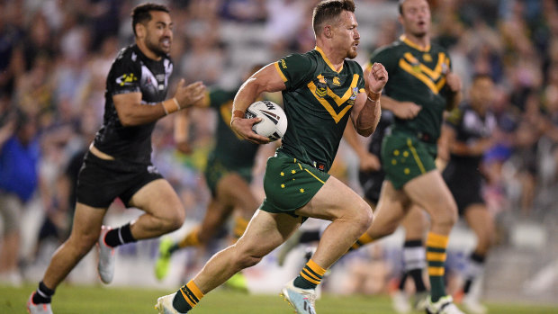 Kangaroos hooker Damien Cook bursts clear to score against New Zealand in Wollongong on Friday night.