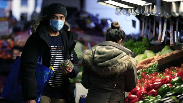 Shoppers at Queen Victoria Market are able to purchase fruit and vegetables, but general merchandise retailers have been forced to shut.