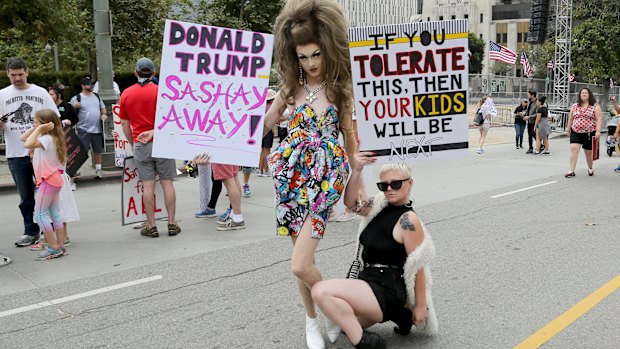 Demonstrators hold signs as they participate in the 'Families Belong Together: Freedom for Immigrants' march on Saturday in Los Angeles.