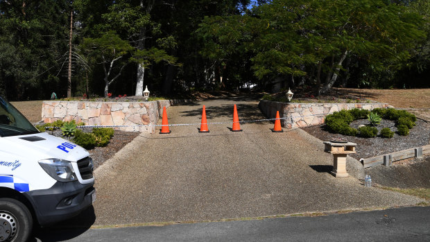 Police tape is seen at the entrance to a driveway at the scene of the alleged double murder.