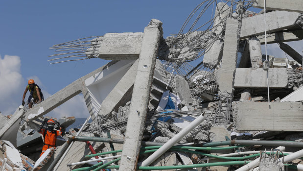 Indonesian rescuers search for people in the ruins of Roa-Roa Hotel in Palu on  Monday.