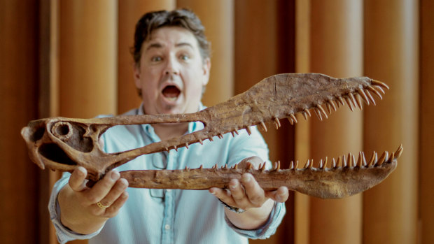 UQ PhD researcher Tim Richards with a reconstruction of Thapunngaka shawi’s skull.