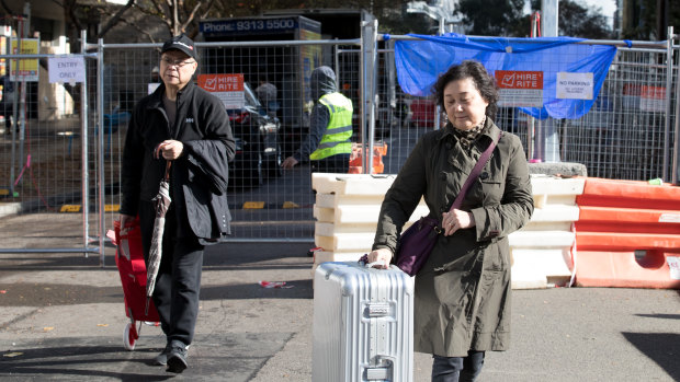 Residents move possessions out of Mascot Towers after an engineer's report said the block may be moving downward. 