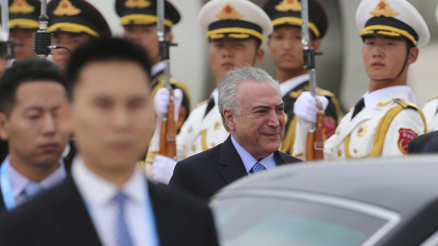 Brazilian President Michel Temer is treated to a guard of honour in Beijing last year.