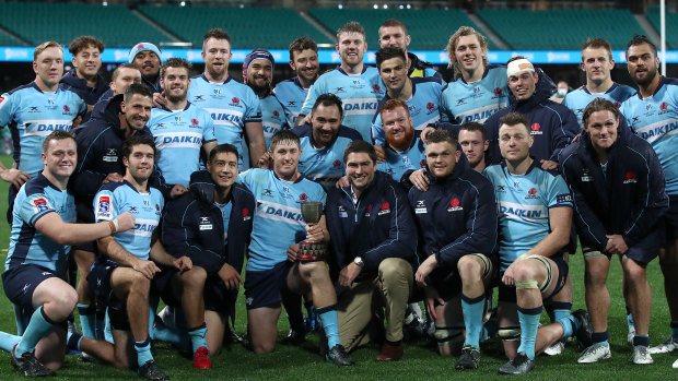 The Waratahs pose for a photo after their emphatic win over the Queensland Reds on Saturday. 