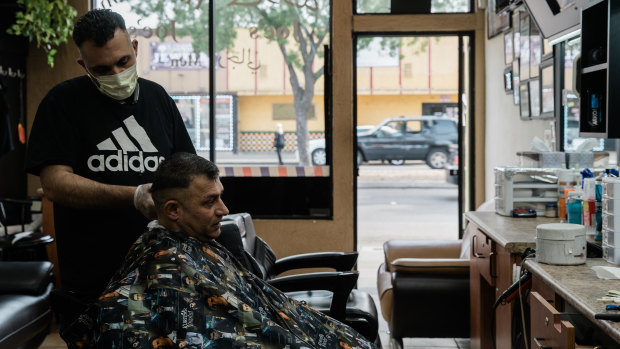 Omar, who is from Lebanon and  part-owner of Joe's Hair Cut in El Cajon, cuts a customer's hair. 