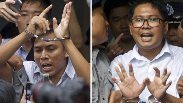 Reuters journalists Kyaw Soe Oo, left, and  Wa Lone, are handcuffed as they are escorted by police out of the court on Monday.