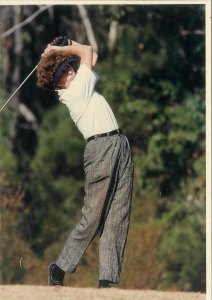 Ginny Bevan teeing off with a powerful swing.