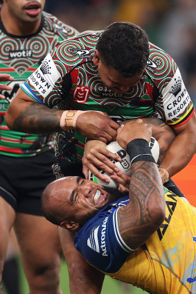 Latrell Mitchell pinches the ball off Junior Paulo during the Indigenous Round clash between Souths and the Eels.
