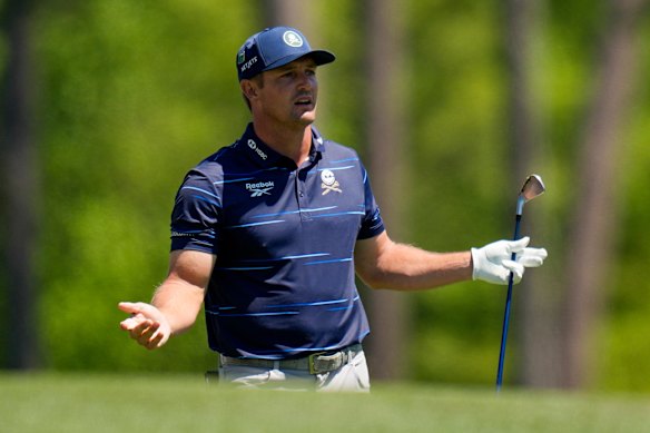 Bryson DeChambeau watches his tee shot on the 12th hole during the first round.