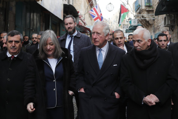 King Charles on a street lined with Union flags as he walks to visit the Mosque of Omar in January 2020 in Bethlehem, Israel. 