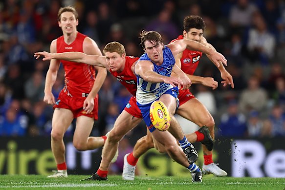 Kangaroo George Wardlaw and Gold Coast’s Matt Rowell show their desperation.