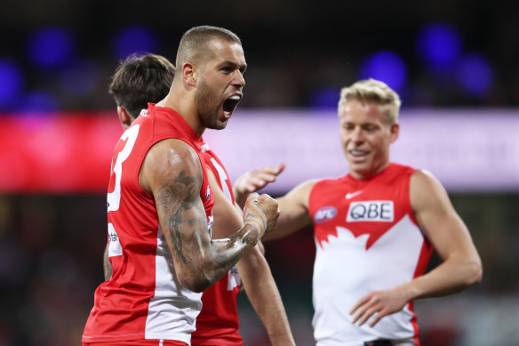 Lance Franklin celebrates with his teammates.