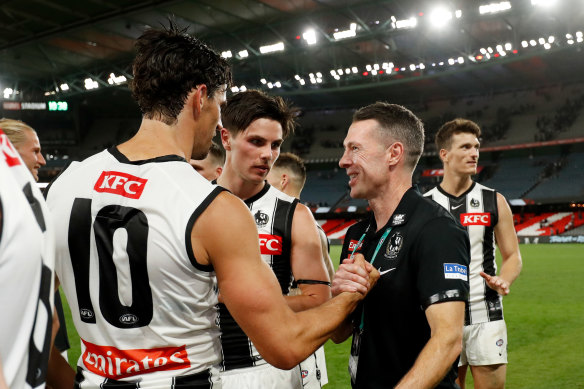 New era: Coach Craig McRae celebrates with Scott Pendlebury. 