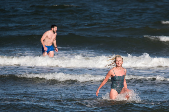 Natasha Herbert and Tony Masterton brave freezing conditions at St Kilda beach for a dip last week.