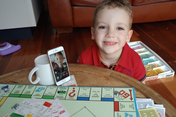 Five-year-old Charlie plays Monopoly with his cousin.