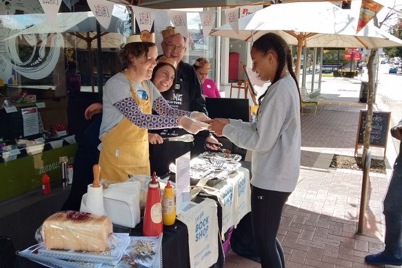 Local authors man the barbecue at one of BSB’s community initiatives. 