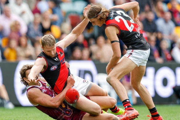 Essendon’s Jake Stringer is tackled by Harry Sharp.