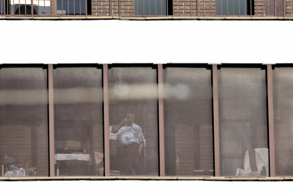 A Corrective Services officer stands guard in front of the hospital room where Ivan Milat was treated at Prince of Wales Hospital in Randwick.
