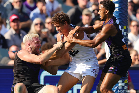 Charlie Curnow of the Blues takes on Luke Ryan of the Dockers and Brandon Walker of the Dockers.