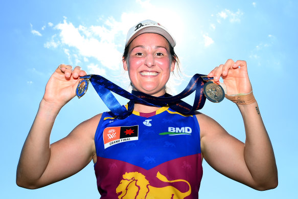 Brisbane captain Breanna Koenen proudly displays the two medals she collected at the 2023 AFLW grand final.