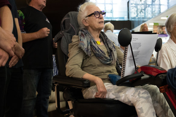 "I wouldn't miss it for the world": Judith Maher sings along in her mobility scooter. 