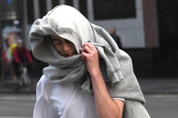 Sporting a hoodie on his head and a swastika on his finger Isaiah Stephens leaves court on Friday. 