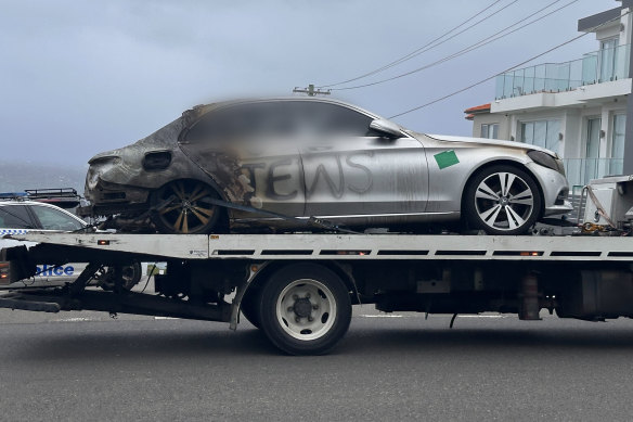 One of the burnt-out cars sprayed with antisemitic graffiti in Sydney.