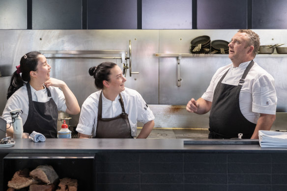 Chef Steven Nelson and team in the open kitchen, which is now partially screened.