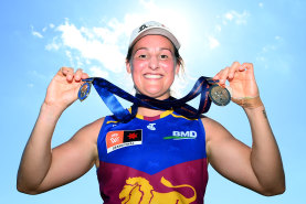 Brisbane captain Breanna Koenen proudly displays the two medals she collected at the 2023 AFLW grand final.