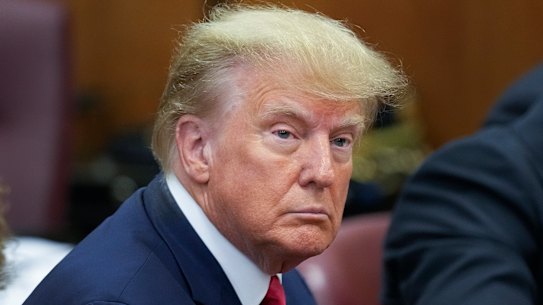 Former president Donald Trump sits at the defence table in court.