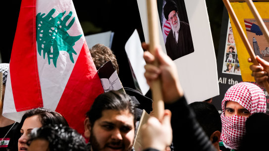 Pro-Palestine protesters hold a placard of Iran’s Supreme Leader, Ayatollah Ali Khamenei, at a rally in Melbourne’s CBD in October 2024.