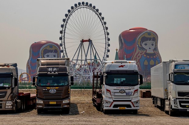 Trucks from Russia and Belarus wait for customs clearance at a parking lot in Manzhouli, a Chinese town on the border of Russia.