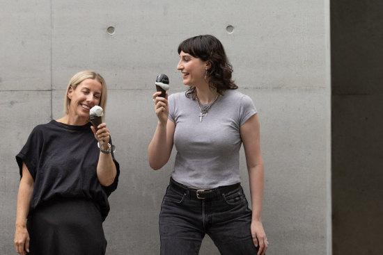 Georgia Bainbridge (left) and Taya Oxenham try the grey ice-cream at M Pavilion.