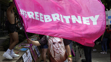 A Britney Spears supporter waves a “Free Britney” flag outside a court hearing concerning the pop singer’s conservatorship.