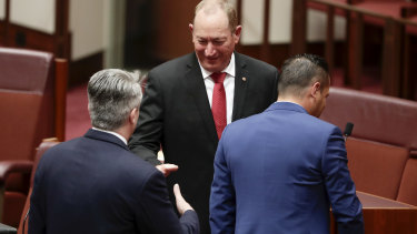 Mathias Cormann shakes hands with Fraser Anning after his controversial first speech. A spokeswoman has said Senator Cormann was merely following protocol.
