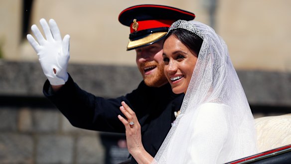 Beneath a bluebird sky, the newly married couple take a ride in a horse-drawn carriage.