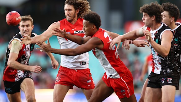 Joel Amartey and Tom Hickey vie for the ball against St Kilda