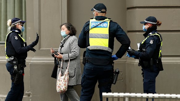 A woman is issued a fine on August 9, 2020 in Melbourne.